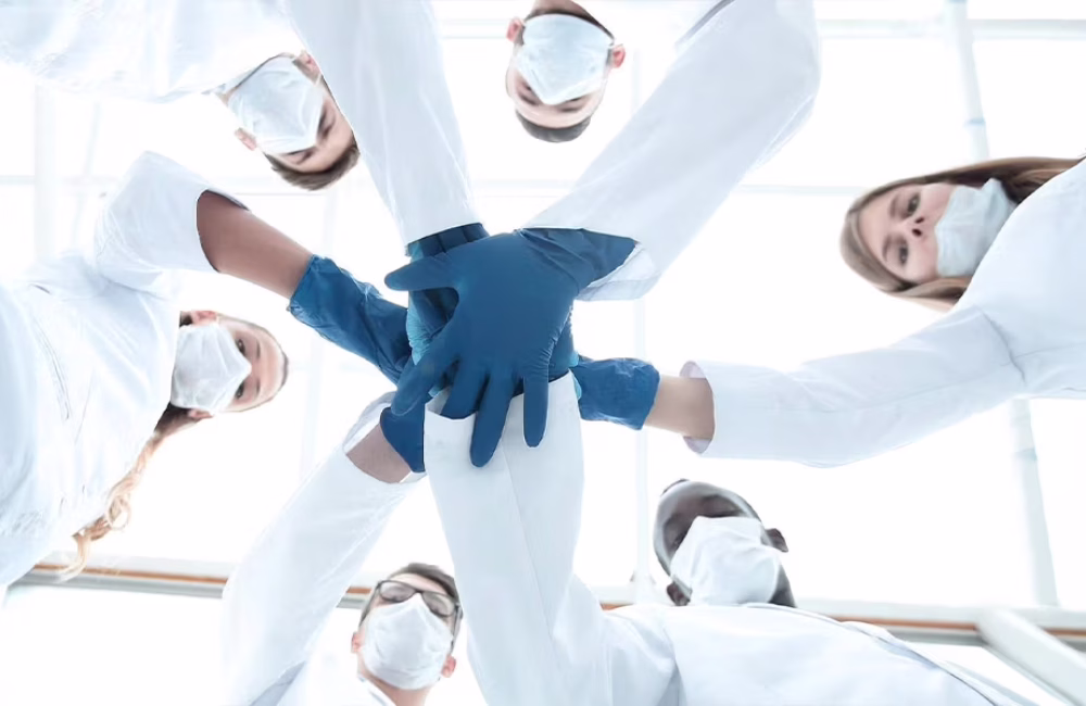 Physicians standing together in a clinical setting, symbolizing teamwork and stress support.